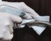 hands-with-gloves-disinfecting-door-handle